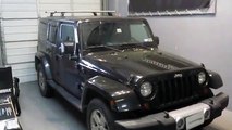 Jeep Wrangler Unlimited with Thule Rapid Podium Aeroblade Roof Rack on Tracks by Rack Outfitters