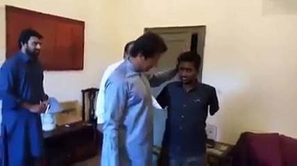 Imran Khan meets a worker and his family who has no arms in Bani Gala on his wish