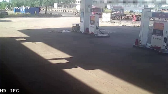 Lorry bursts into flames after crash at petrol station