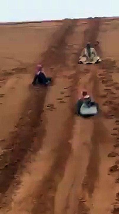 Arab Man Desert Sliding as Funny Style in Dubai United Arab Emirates.