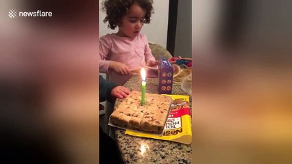 Boy struggles to blow out birthday cake candle