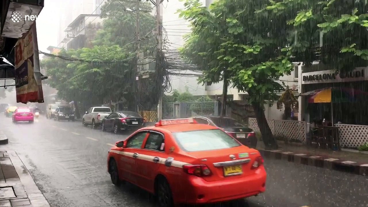 Two enjoy meal under umbrella through monsoon