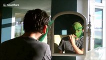 Stop motion footage of Grinch impressionist applying his prosthetic mask