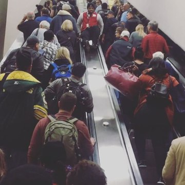 Travelers Walk Up Stopped Escalator During Atlanta Airport Power Outage