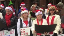 Carolers Protest Tax Bill By Singing Revised Christmas Songs Outside Office of Senator John Cornyn