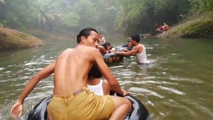 Arung jeram mengarungi sungai saling berpegangan ban dalam mobil sebagai pelampung