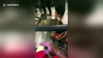 Little girl trapped in escalator by her hair