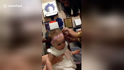 Baby's surprised reaction when she hears clearly for the first time