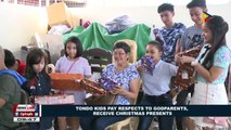 Tondo kids pay respects to godparents, receive Christmas presents