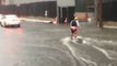 Man Paddles and Surfs Through Flooded Honolulu Streets