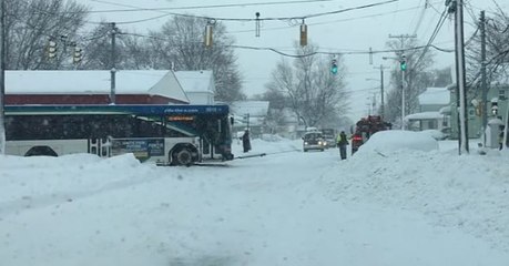 Tow Truck Pulls Erie Bus Through Snowy Street