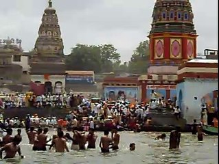 The pilgrims bathing in the Bhima river and celebrating on its bank