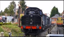 Steam Engine pulling out of a Train Station with Freight Wagons