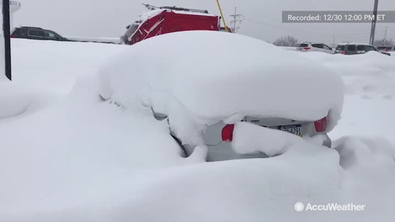 Car completely buried under lake-effect snow in Erie