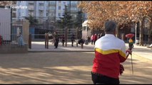 Elderly Chinese man plays diabolo on unicycle