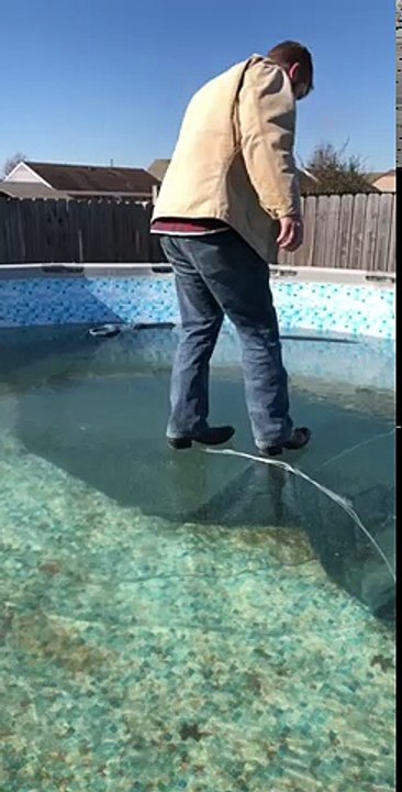 Man Breaks Ice on Pool
