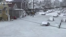 Parked cars trapped in frozen floodwater during US 'bomb cyclone'