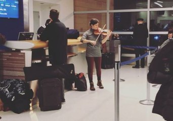 Violinist Plays to Travelers at JFK Airport