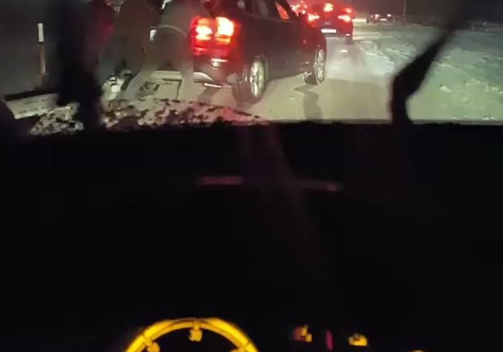Passersby Help to Dislodge Car as Snowstorms Hi...