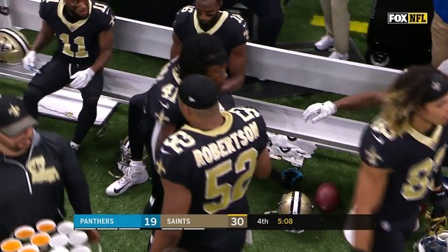 New Orleans Saints running back Alvin Kamara hands out Air Heads to his teammates following TD