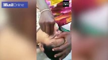Woman has her eyes 'cleaned' with a SAFETY PIN which is quickly scraped over her eyeball by Indian healer to remove dirt