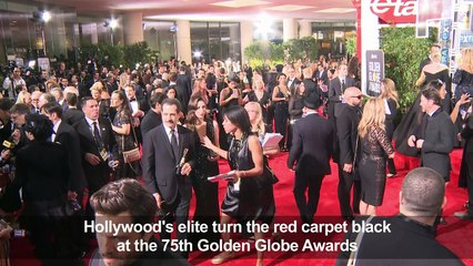 Hollywood's elite turn the red carpet black at the Golden Globes