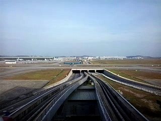 Airplanes passing at KLIA over the aerotrain bridge