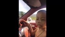 un enfant chinois est au volant d'une voiture de luxe