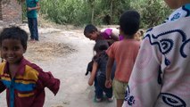 Bihari and Delhi's Children playing with lamb in Harpur Village