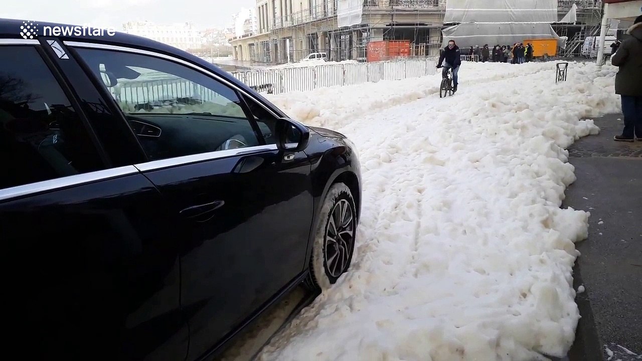 Huge waves of foam swamp seafront in Biarritz, France