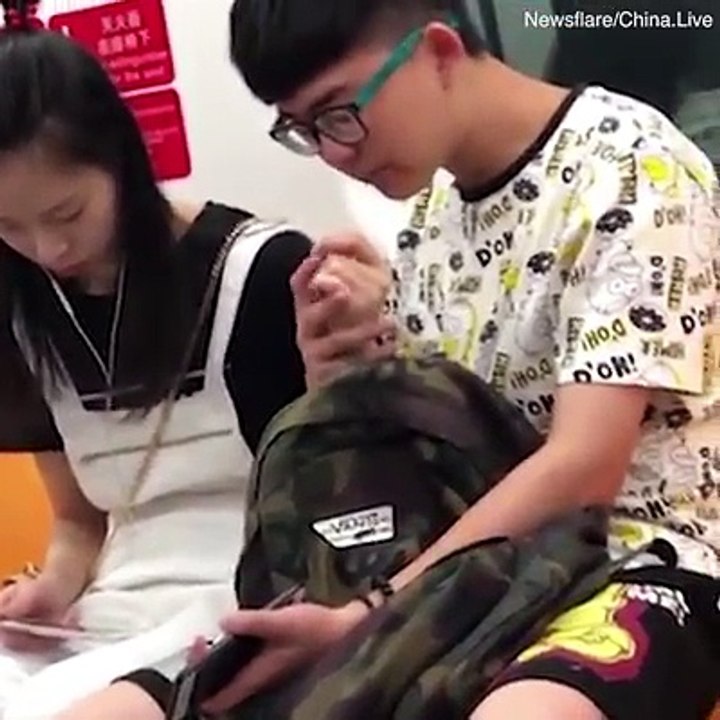 This guy is using his girlfriend’s finger to pick his nose!! 