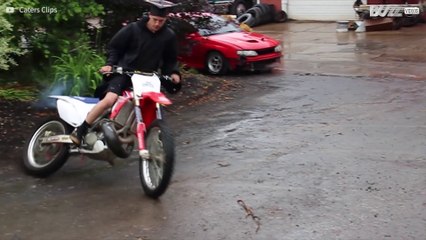 Young man celebrates graduation with dirt bike tricks