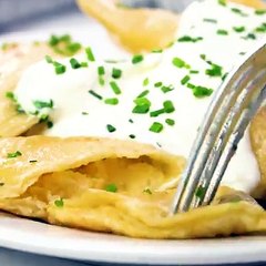 Homemade Pierogi are stuffed with a flavorful potato and cheese mixture, boiled, and fried up in melted butter for a delicious, indulgent, total comfort food di