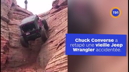 Une jeep escalade une falaise à 90 degrés