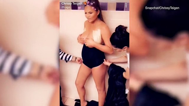 Pregnant & topless Chrissy Teigen holds breasts BTS at Lip Sync