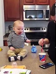 Daddy, put the phone away! Baby needs another bite! Ice cream