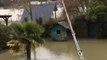 French Fisherman Casts Line From Balcony Into Seine Floodwaters