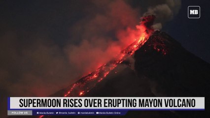 Supermoon rises over erupting Mayon volcano