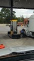 Truck Driver in Wheelchair Cleans Semi at Gas Station