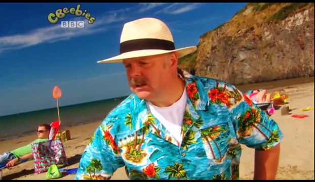 Gigglebiz Captain Adorable helps put the finishing touches to a holidaymaker's sandcastle