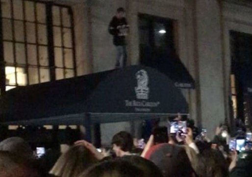 Man Climbs Awning, Shotguns Beer as Eagles Fans Celebrate Super Bowl Win