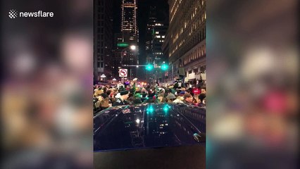 Eagles fans jump on cars and vandalize street light after Super Bowl win