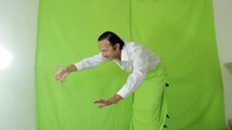 Man on green screen sticking out of somewhere waves hands and shows a thumb up. stock footage