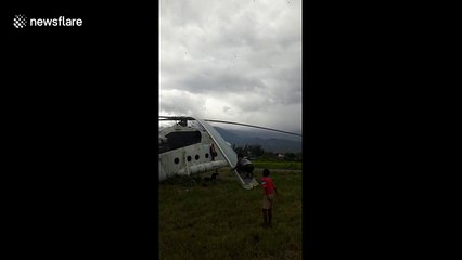 Children enjoy swing ride on the blades of a helicopter in Indonesia