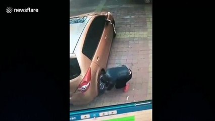 Man’s epic fail at trying to get money stuck under tire