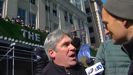 Eagles fans chuck footballs onto Doug Pederson's float along parade route