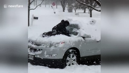 Boy uses his body instead of a brush during Chicago snowstorm