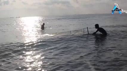 A fisherman caught Fish in the sea wave