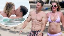 Mark Wahlberg displays his six pack and chiseled chest as he packs on the PDA with bikini-clad wife Rhea on the beach in Barbados.