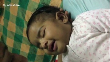 Sleeping baby smiles when mum says 'I love you' to her